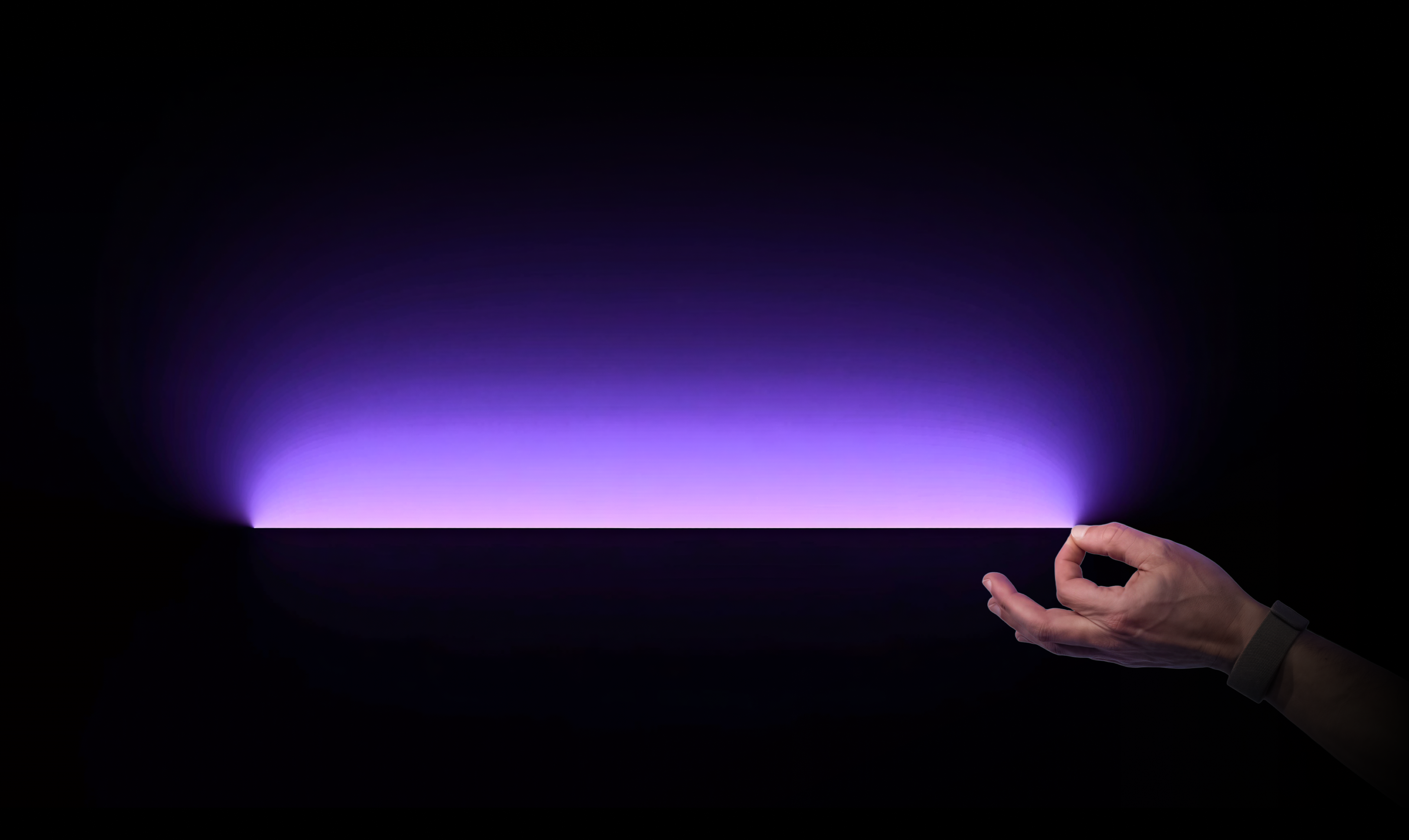 A gesture directed toward a purple interaction field